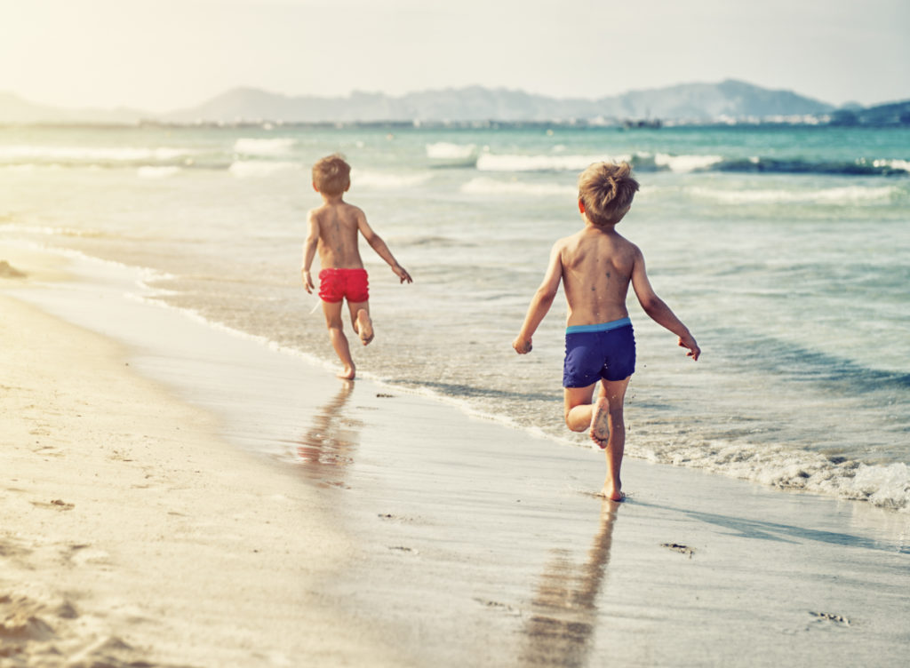 kids running on the beach